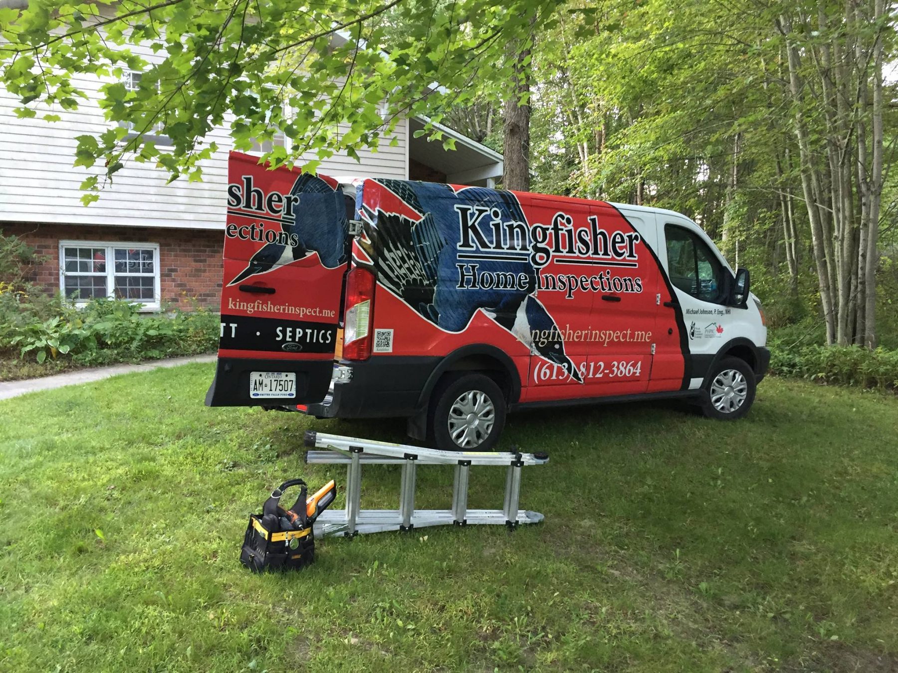 Kingfisher Inspections red, white, and blue truck alonside a ladder and toolbox