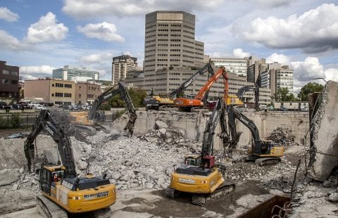 Demolition machines at a job site taking down concrete