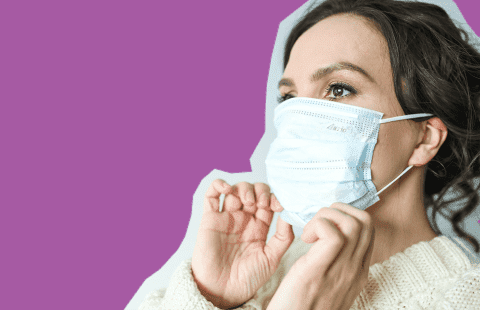 Woman putting on a mask